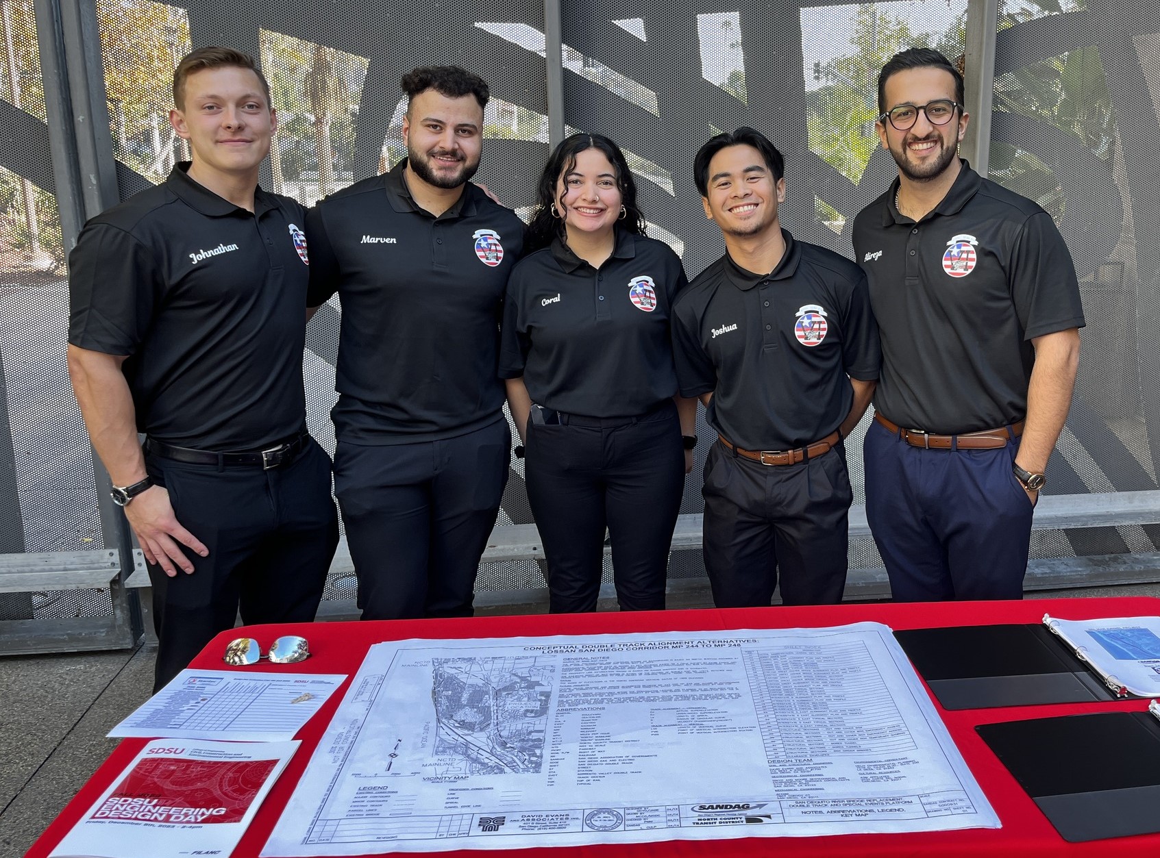 A CCEE professor and a CCEE Design Day project team of five students 